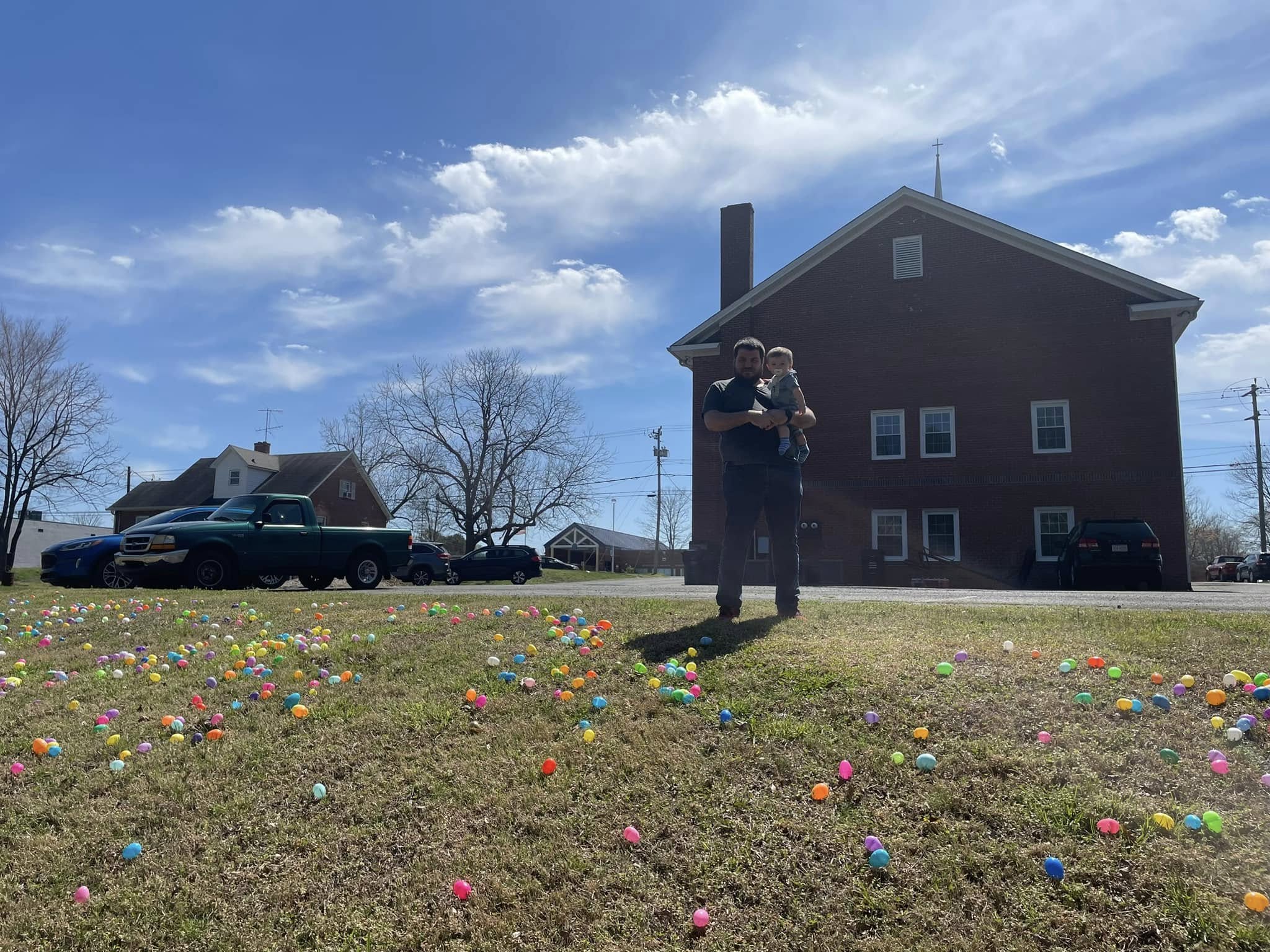 Youth gathering near church exterior during seasonal event